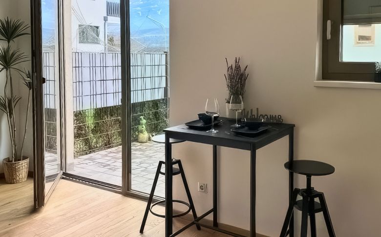 Living area with dining table and terrace door with mountain view