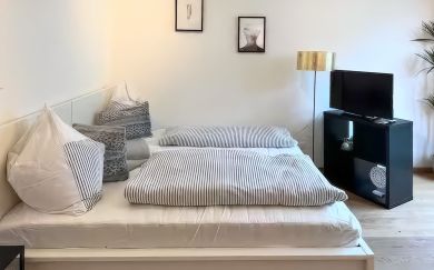 Double bed in the bright living and sleeping area