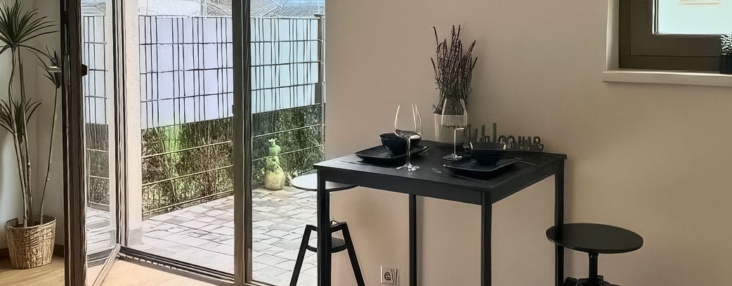 Living area with dining table and terrace door with mountain view