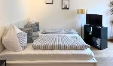 Double bed in the bright living and sleeping area